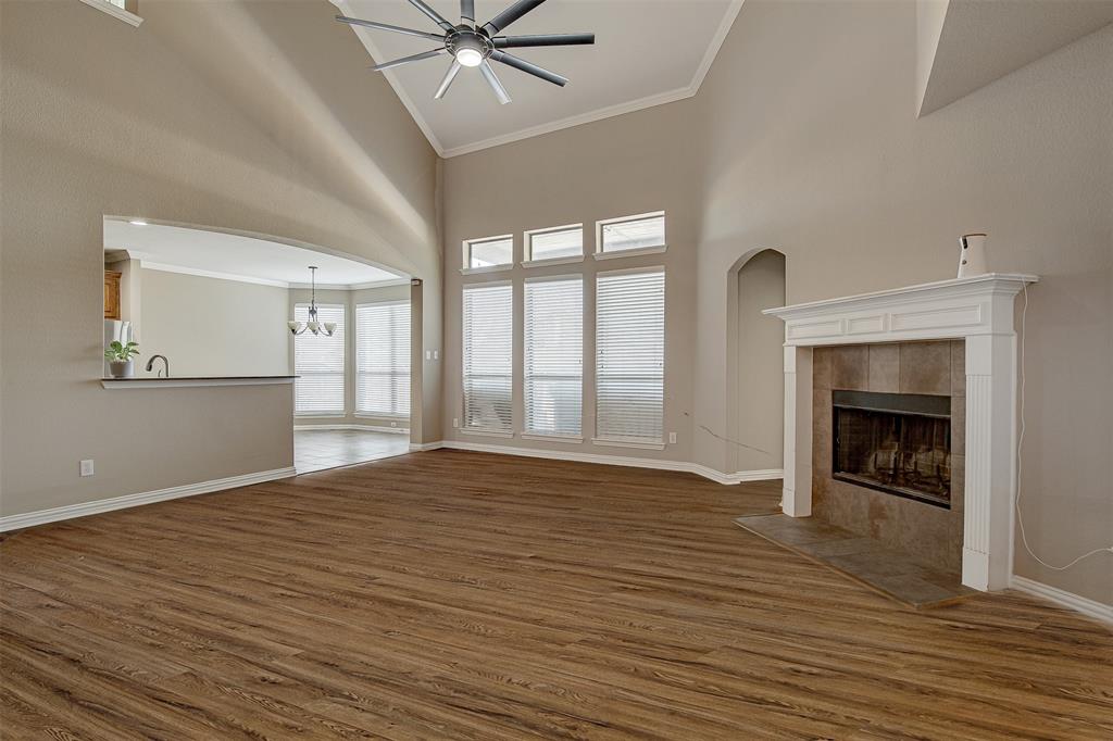 328 Tioga Street Burleson, TX 76028 - Photo 5 of 29 wooden floor fireplace and windows in an empty room