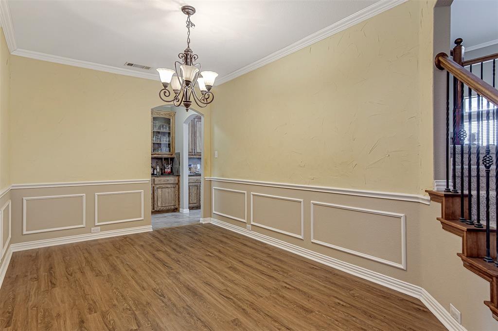 328 Tioga Street Burleson, TX 76028 - Photo 7 of 29 a view of an empty room with a window and wooden floor
