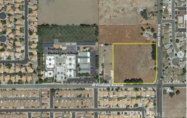 view of a balcony with a couple of cars parked in front of it