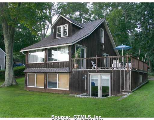 a view of house with a yard and balcony