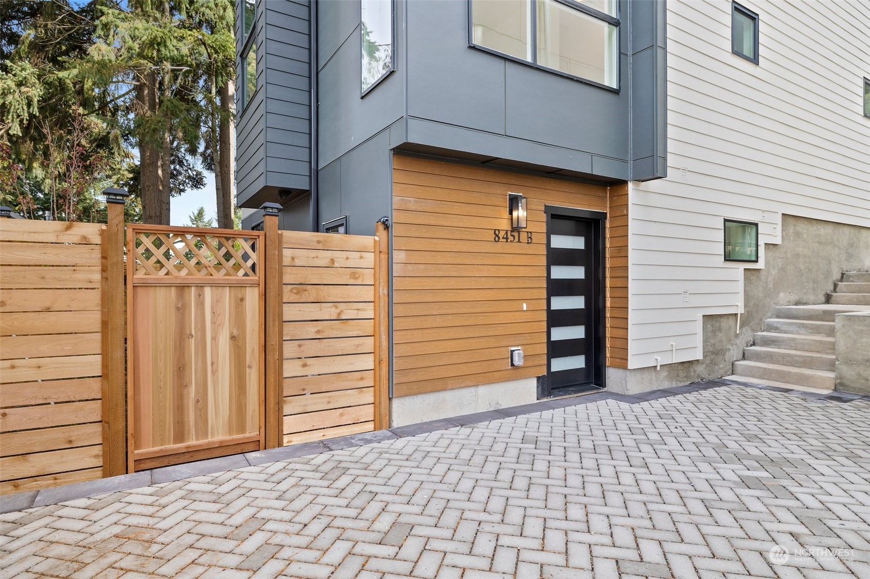 8451 24th Avenue Southwest, Unit B Seattle, WA 98106 - Photo 1 of 20 a view of a house with a door and wooden walls