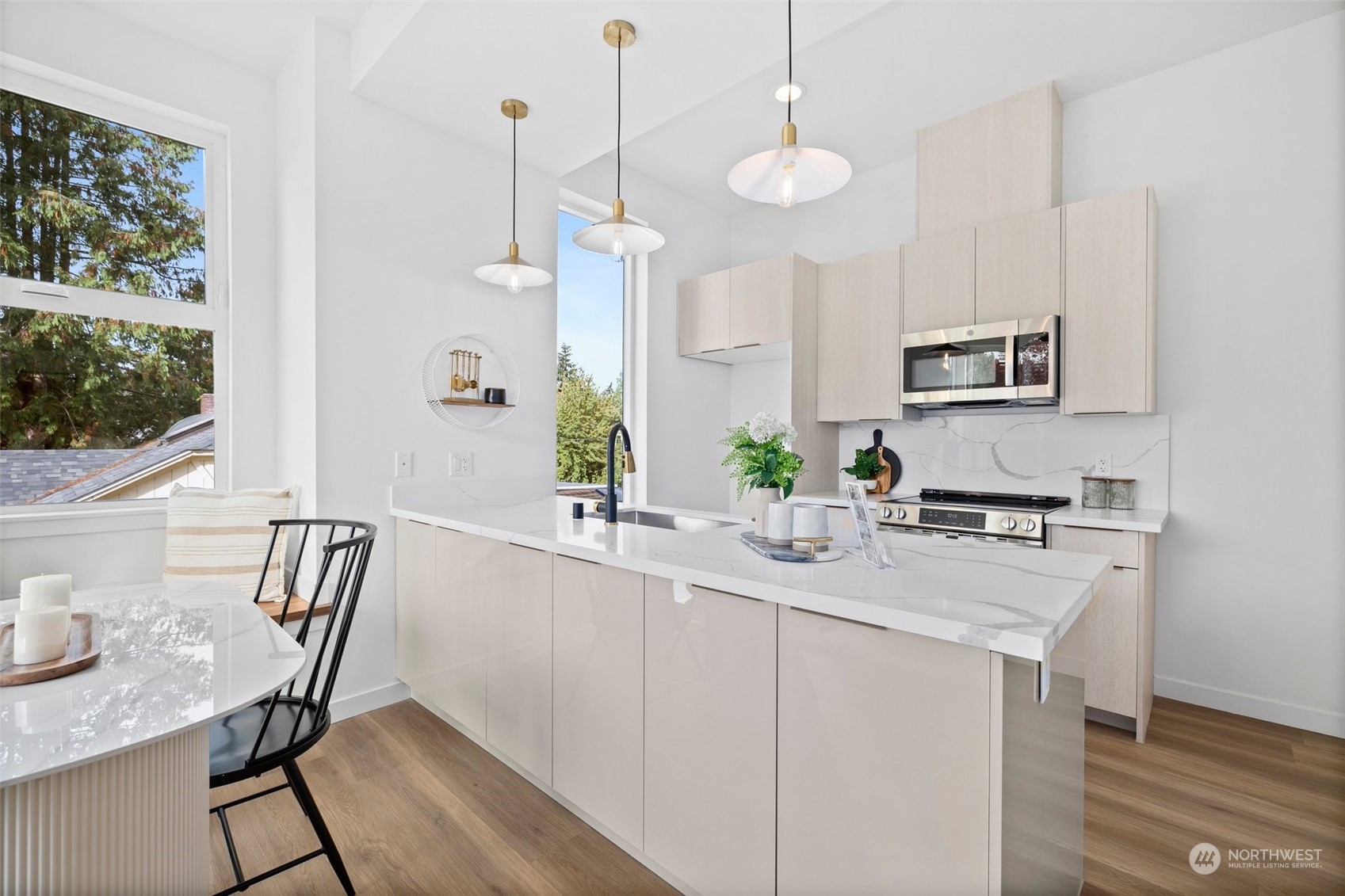 8451 24th Avenue Southwest, Unit B Seattle, WA 98106 - Photo 2 of 20 a kitchen with a table chairs stove and microwave