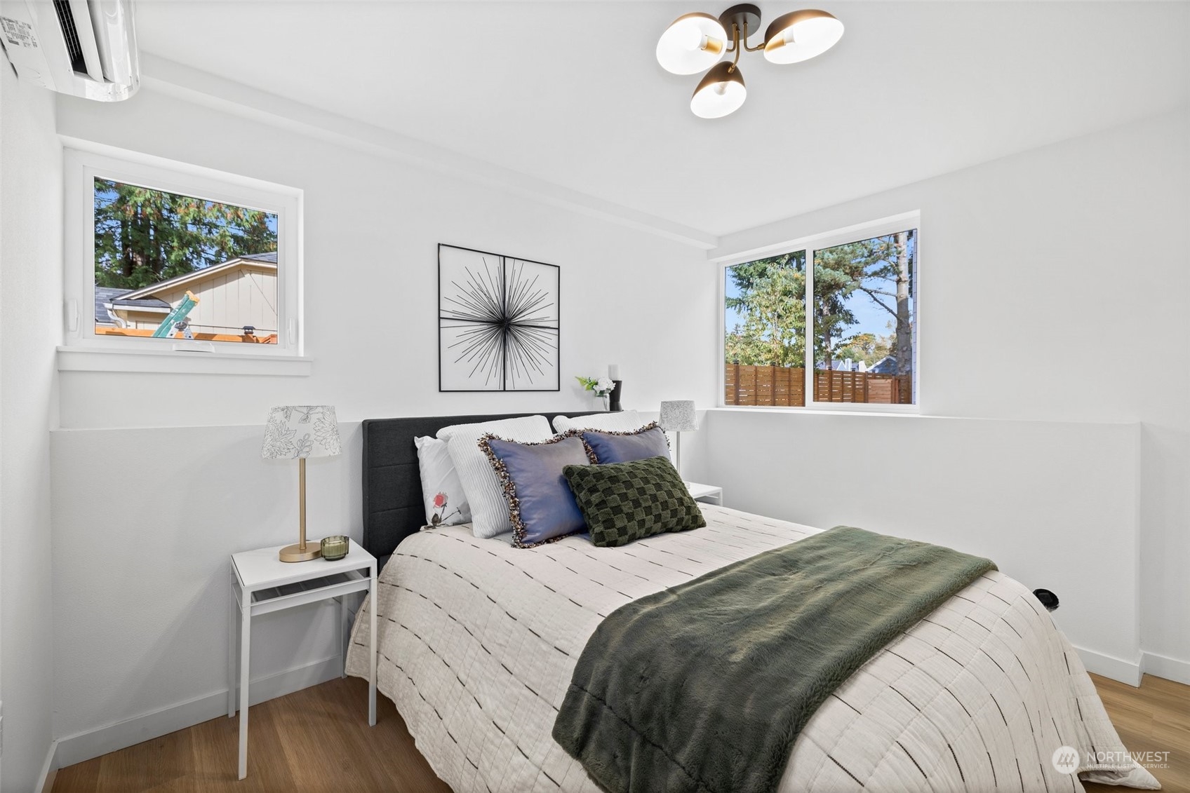 8451 24th Avenue Southwest, Unit B Seattle, WA 98106 - Photo 8 of 20 a bedroom with a bed and a chandelier