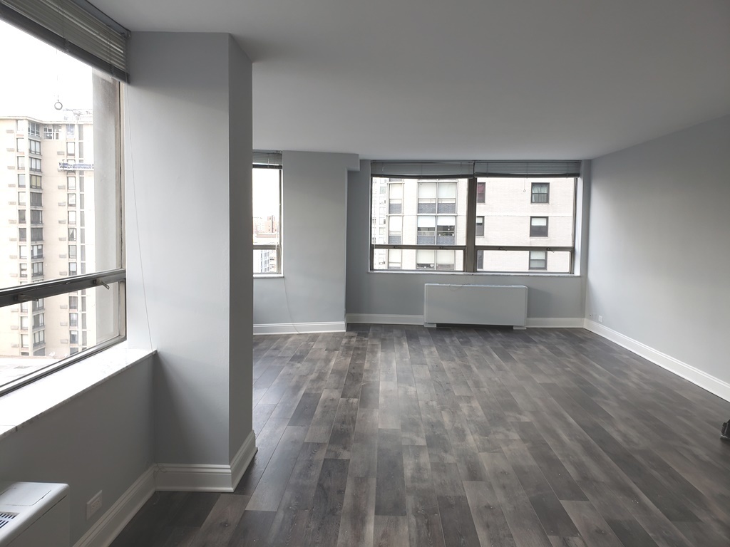 5701 North Sheridan Road, Unit 12L Chicago, IL 60660 - Photo 11 of 42 an empty room with wooden floor and windows
