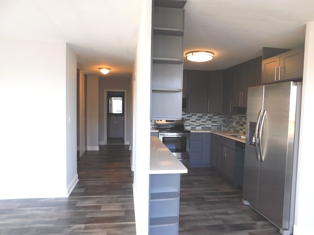 5701 North Sheridan Road, Unit 12L Chicago, IL 60660 - Photo 12 of 42 a kitchen with a refrigerator and a sink