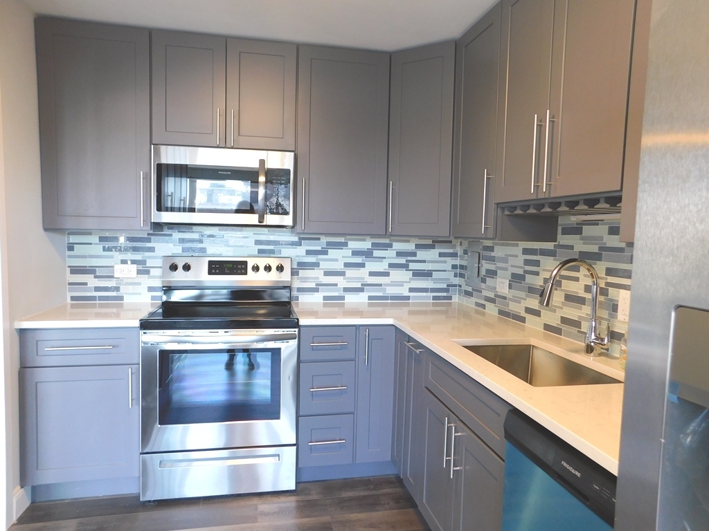 5701 North Sheridan Road, Unit 12L Chicago, IL 60660 - Photo 13 of 42 a kitchen with a sink stove and cabinets