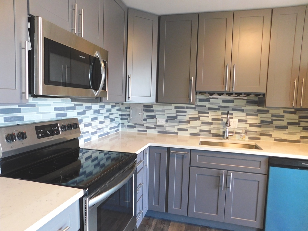 5701 North Sheridan Road, Unit 12L Chicago, IL 60660 - Photo 14 of 42 a kitchen with stainless steel appliances granite countertop a sink stove and microwave