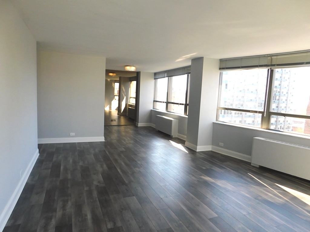 5701 North Sheridan Road, Unit 12L Chicago, IL 60660 - Photo 6 of 42 an empty room with wooden floor and windows