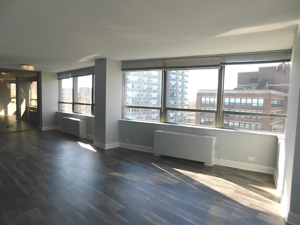 5701 North Sheridan Road, Unit 12L Chicago, IL 60660 - Photo 8 of 42 an empty room with wooden floor and windows
