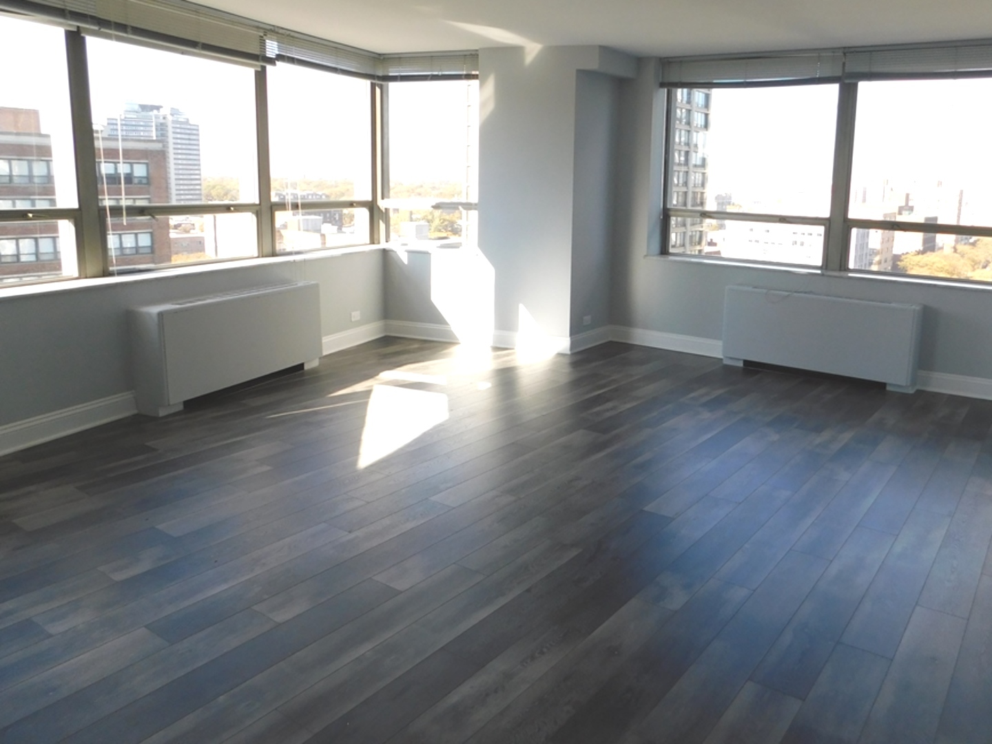 5701 North Sheridan Road, Unit 12L Chicago, IL 60660 - Photo 9 of 42 wooden floor in an empty room with a window