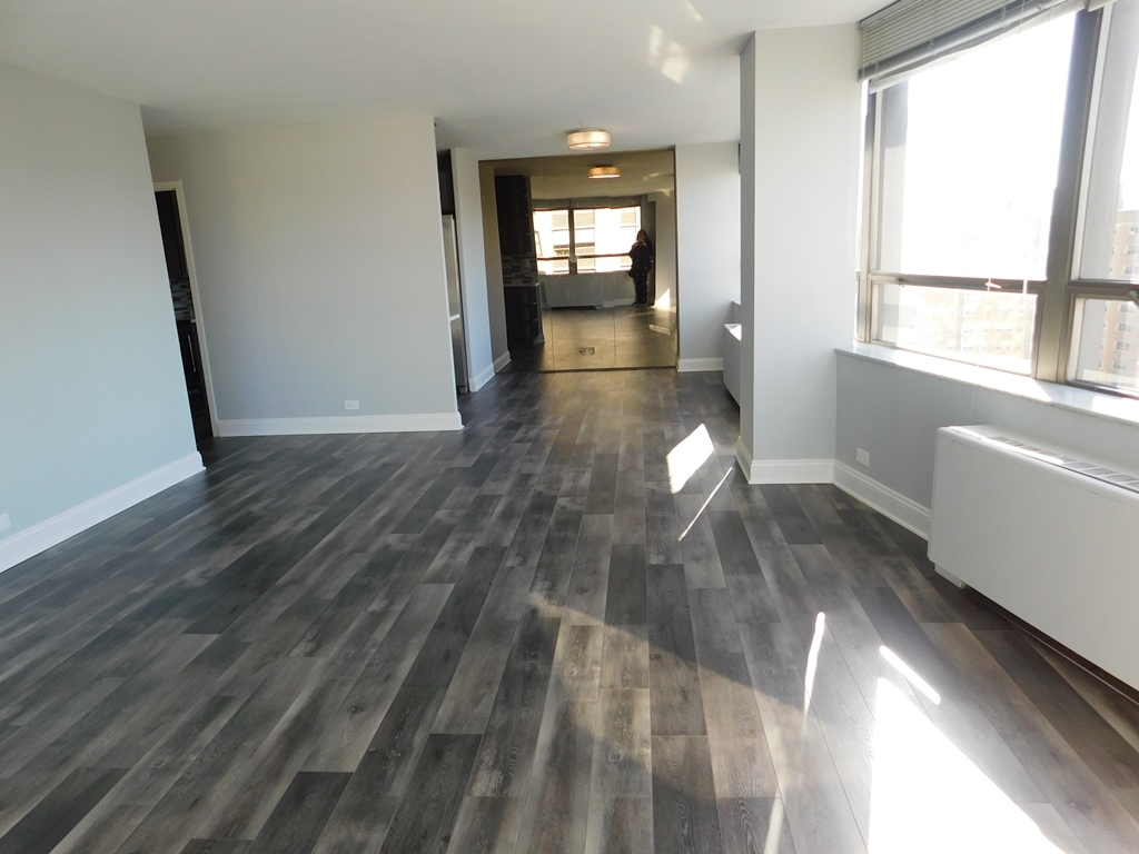 5701 North Sheridan Road, Unit 12L Chicago, IL 60660 - Photo 10 of 42 a view of empty room with wooden floor and fan