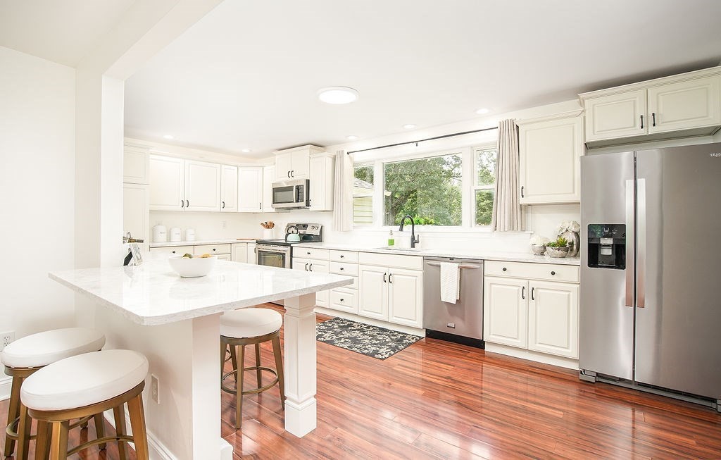 84 Clark Road Sturbridge, MA 01518 - Photo 4 of 30 a kitchen with white cabinets and white appliances