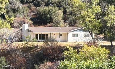42930 Lake Hughes Road Lake Hughes, CA 93532 - Photo 1 of 38 a front view of a house with a garden
