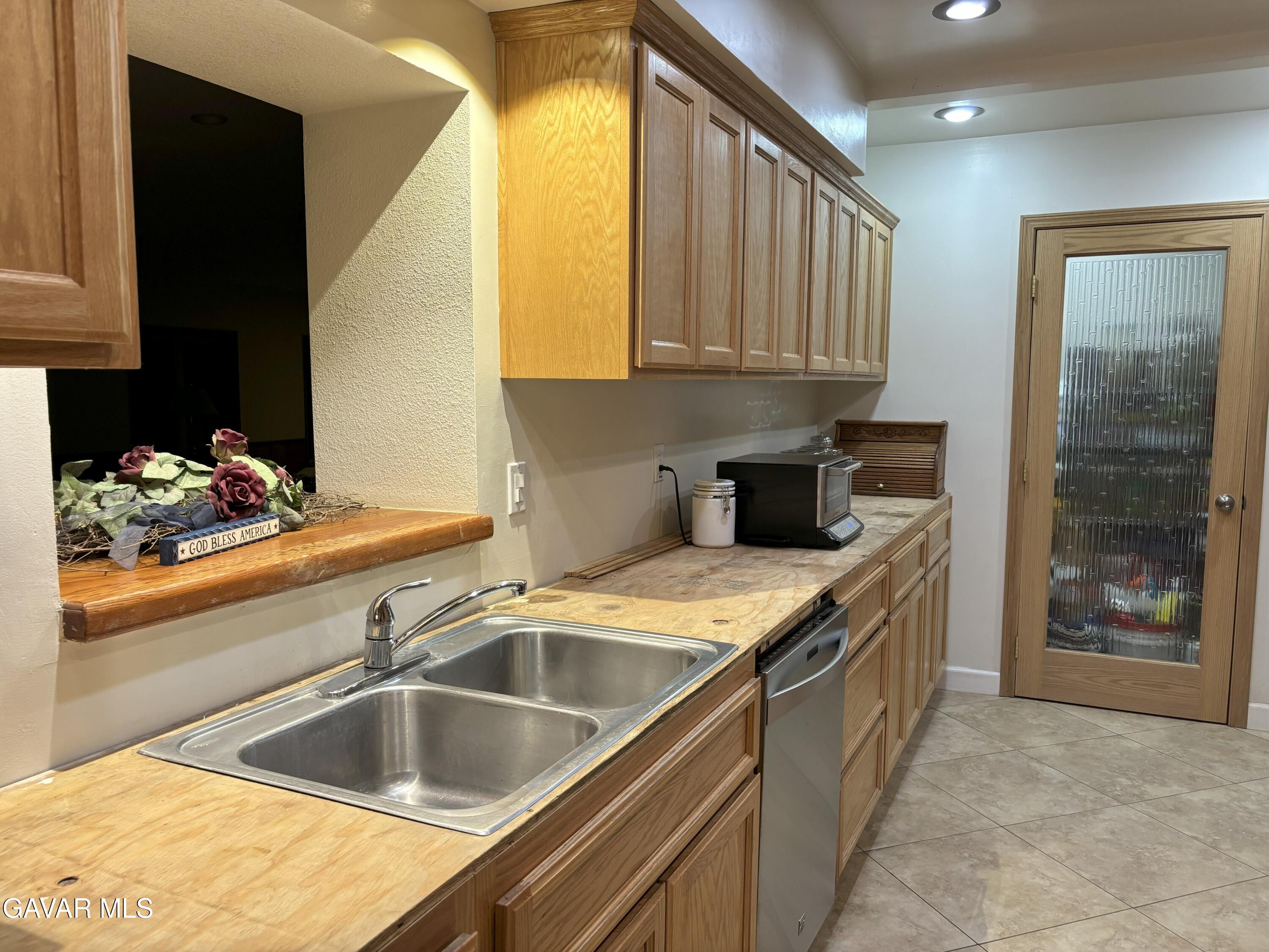 42930 Lake Hughes Road Lake Hughes, CA 93532 - Photo 12 of 38 a kitchen with a sink and cabinets