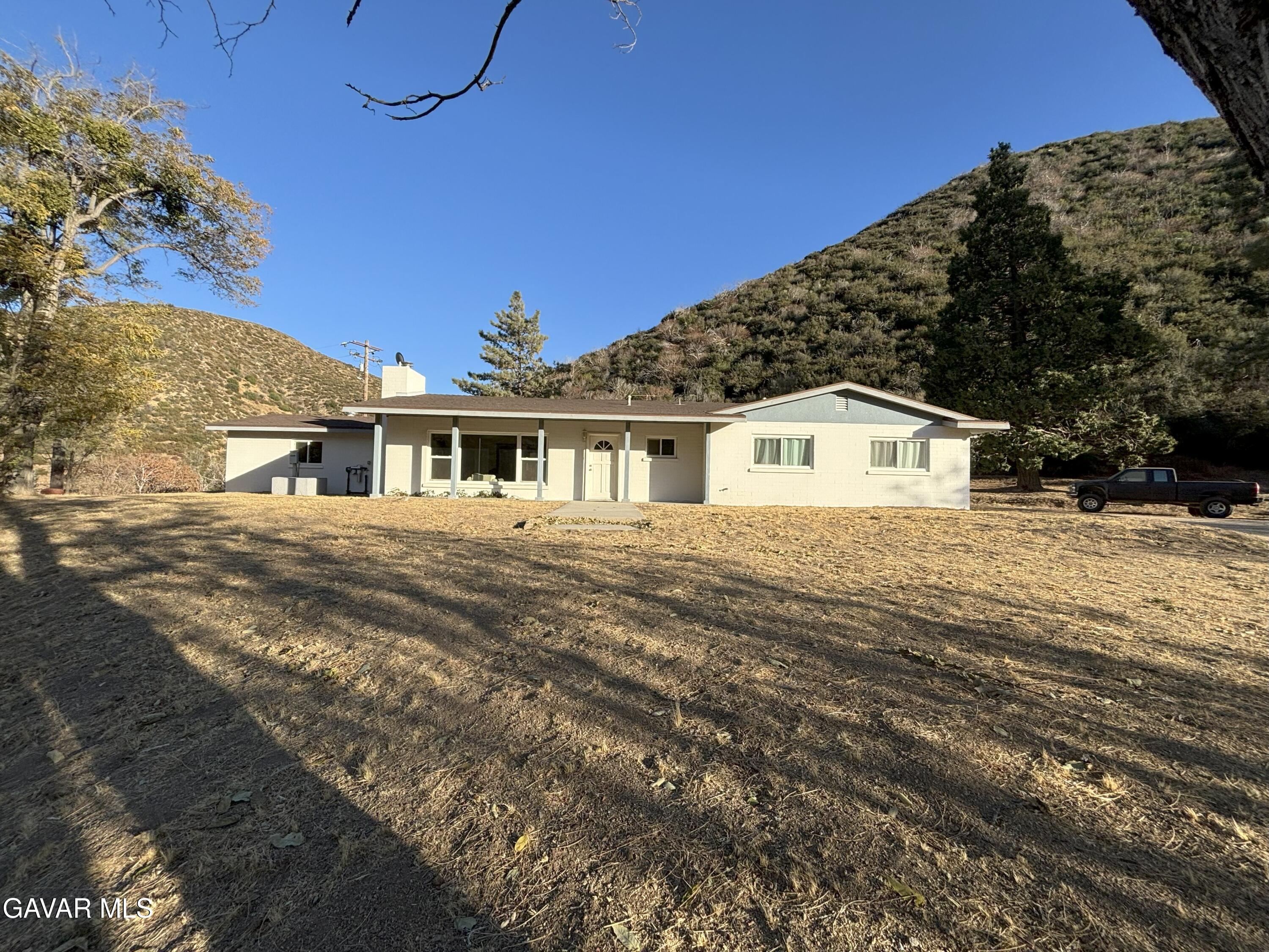 42930 Lake Hughes Road Lake Hughes, CA 93532 - Photo 3 of 38 a front view of a house with a yard