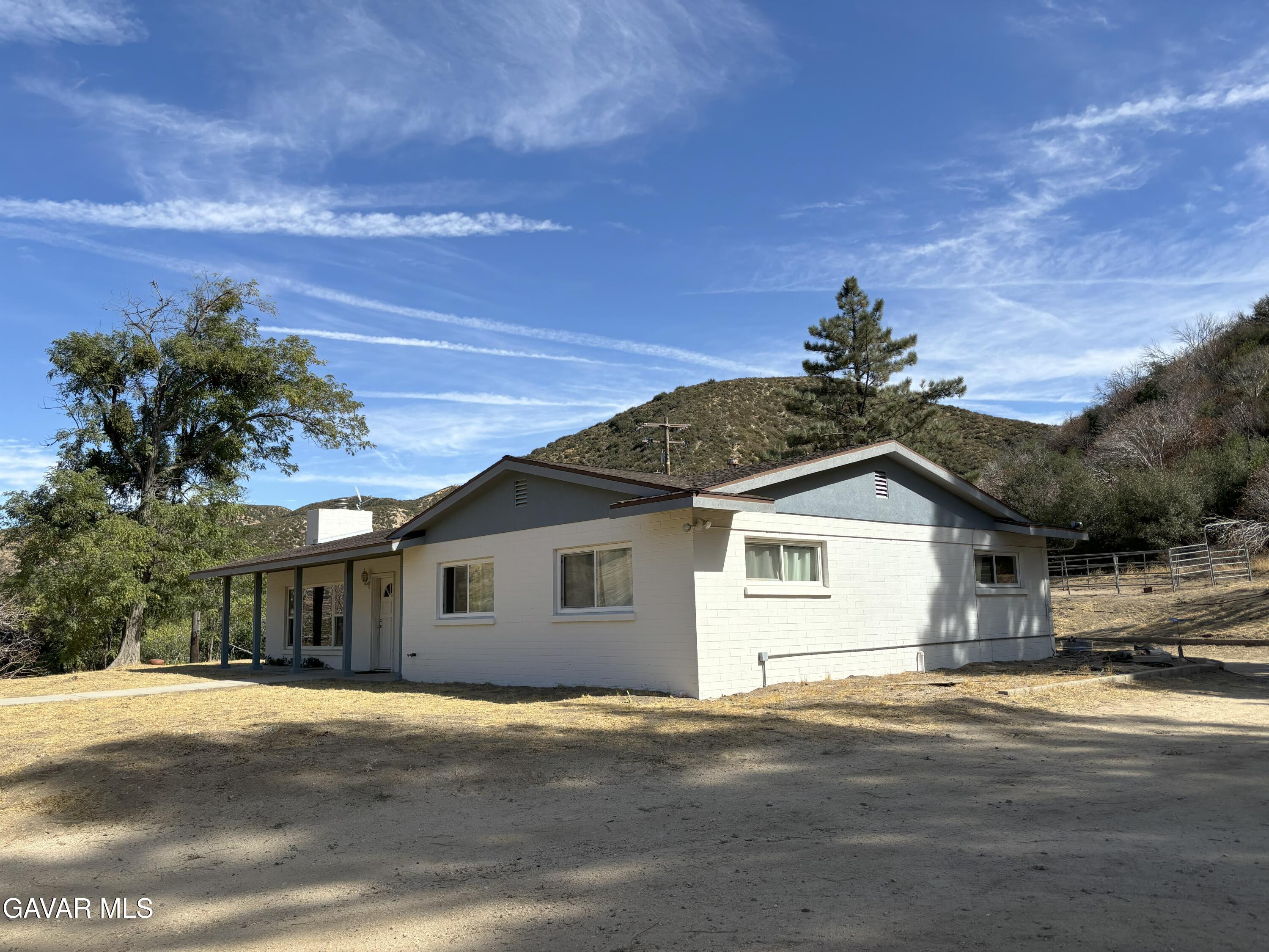 42930 Lake Hughes Road Lake Hughes, CA 93532 - Photo 5 of 38 a front view of a house with a yard