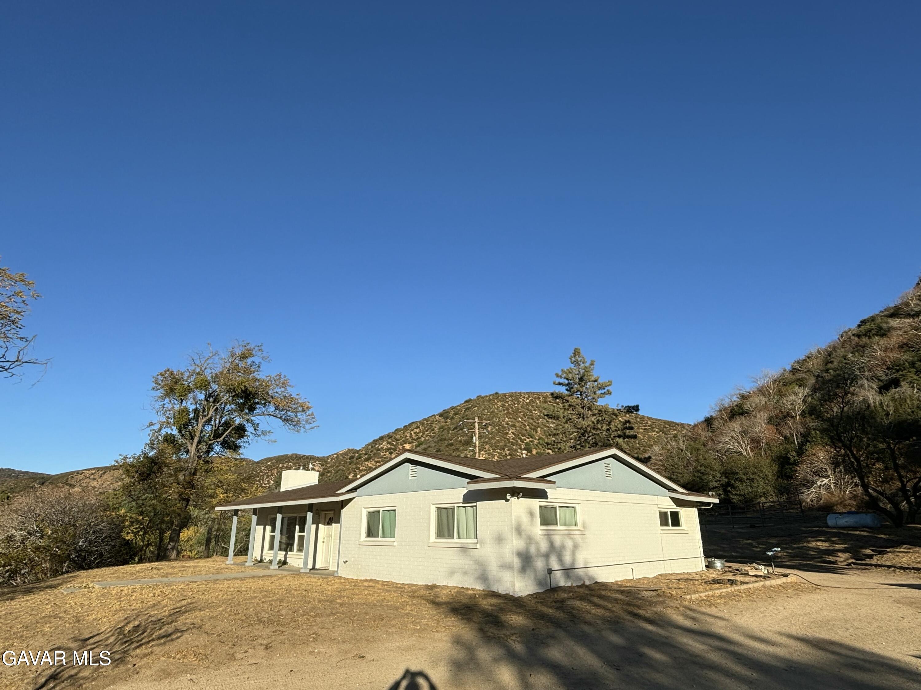 42930 Lake Hughes Road Lake Hughes, CA 93532 - Photo 9 of 38 a front view of a house with a yard