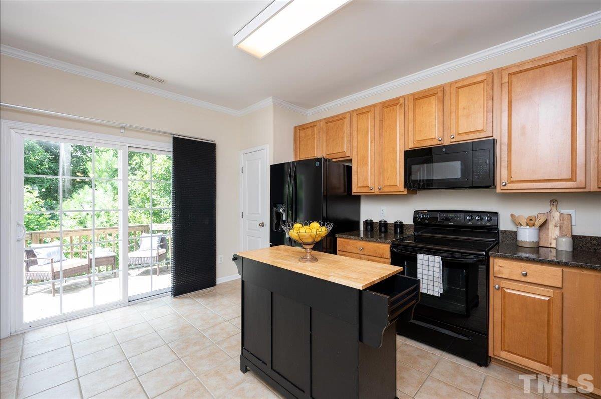 160 Grey Elm Trail Durham, NC 27713 - Photo 11 of 25 a kitchen with stainless steel appliances granite countertop a stove sink and cabinets