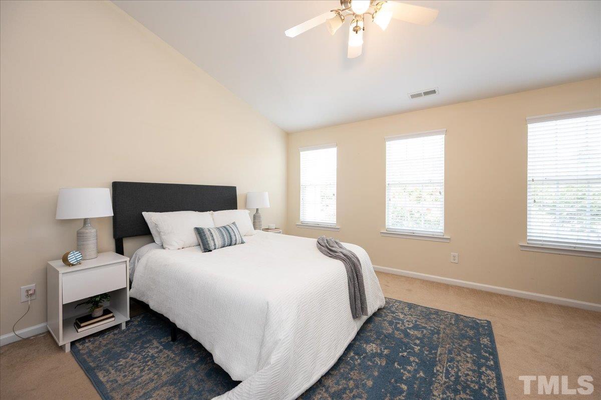 160 Grey Elm Trail Durham, NC 27713 - Photo 14 of 25 a bedroom with a large bed and a chandelier
