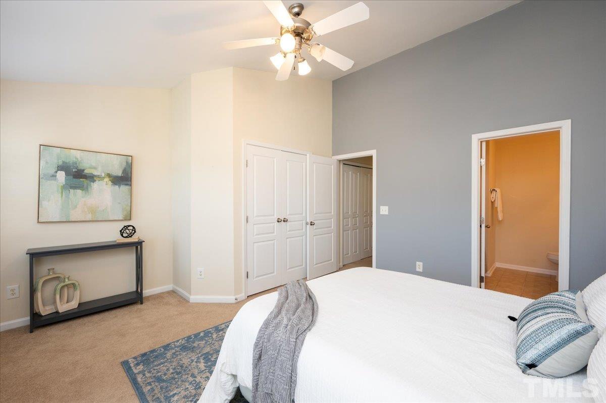 160 Grey Elm Trail Durham, NC 27713 - Photo 15 of 25 a bedroom with a bed and a chandelier