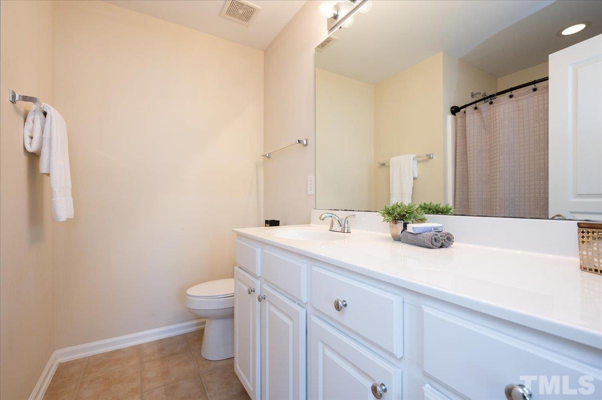 160 Grey Elm Trail Durham, NC 27713 - Photo 16 of 25 a bathroom with a sink a toilet and mirror