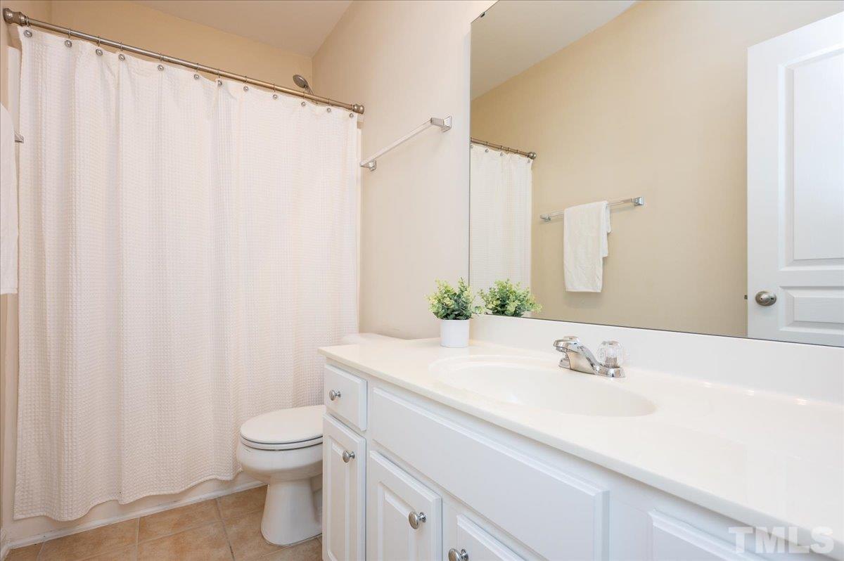 160 Grey Elm Trail Durham, NC 27713 - Photo 23 of 25 a bathroom with a sink a toilet and a mirror