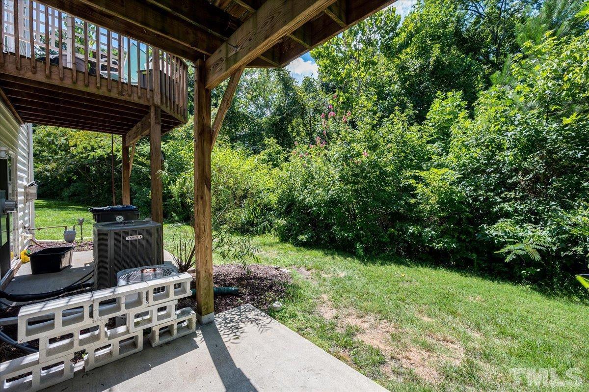 160 Grey Elm Trail Durham, NC 27713 - Photo 24 of 25 a view of a chairs and table in the back yard of the house