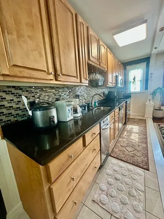 a kitchen with stainless steel appliances a sink and cabinets