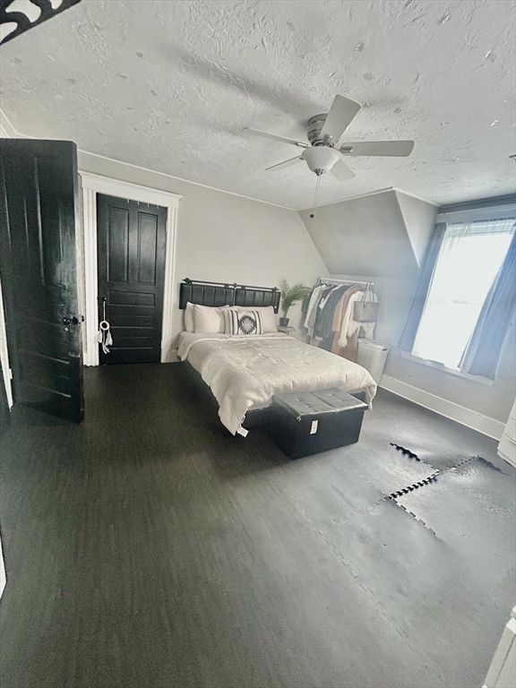 114 Lovell Street Worcester, MA 01603 - Photo 19 of 39 a spacious bedroom with a bed and a chandelier