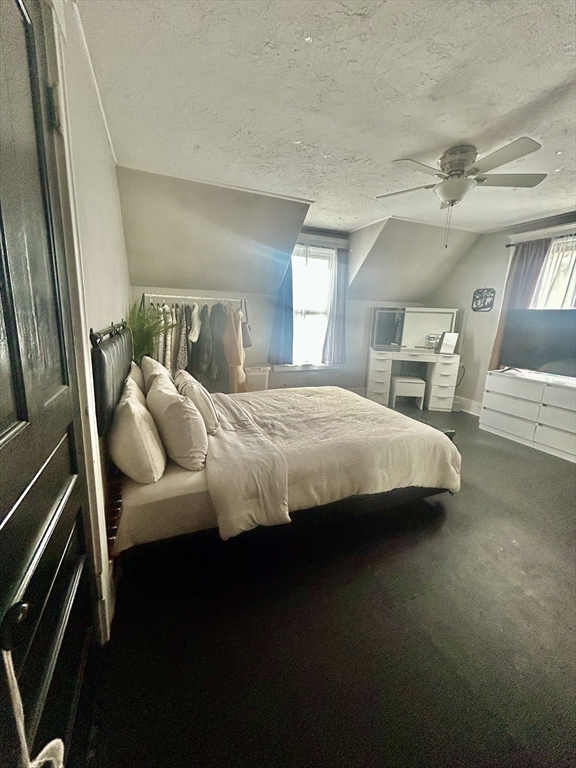 114 Lovell Street Worcester, MA 01603 - Photo 24 of 39 a bedroom with a bed and a chandelier