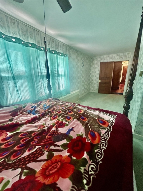 114 Lovell Street Worcester, MA 01603 - Photo 29 of 39 a bed sitting in a room next to a window