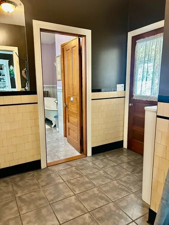 a bathroom with a toilet a sink and mirror