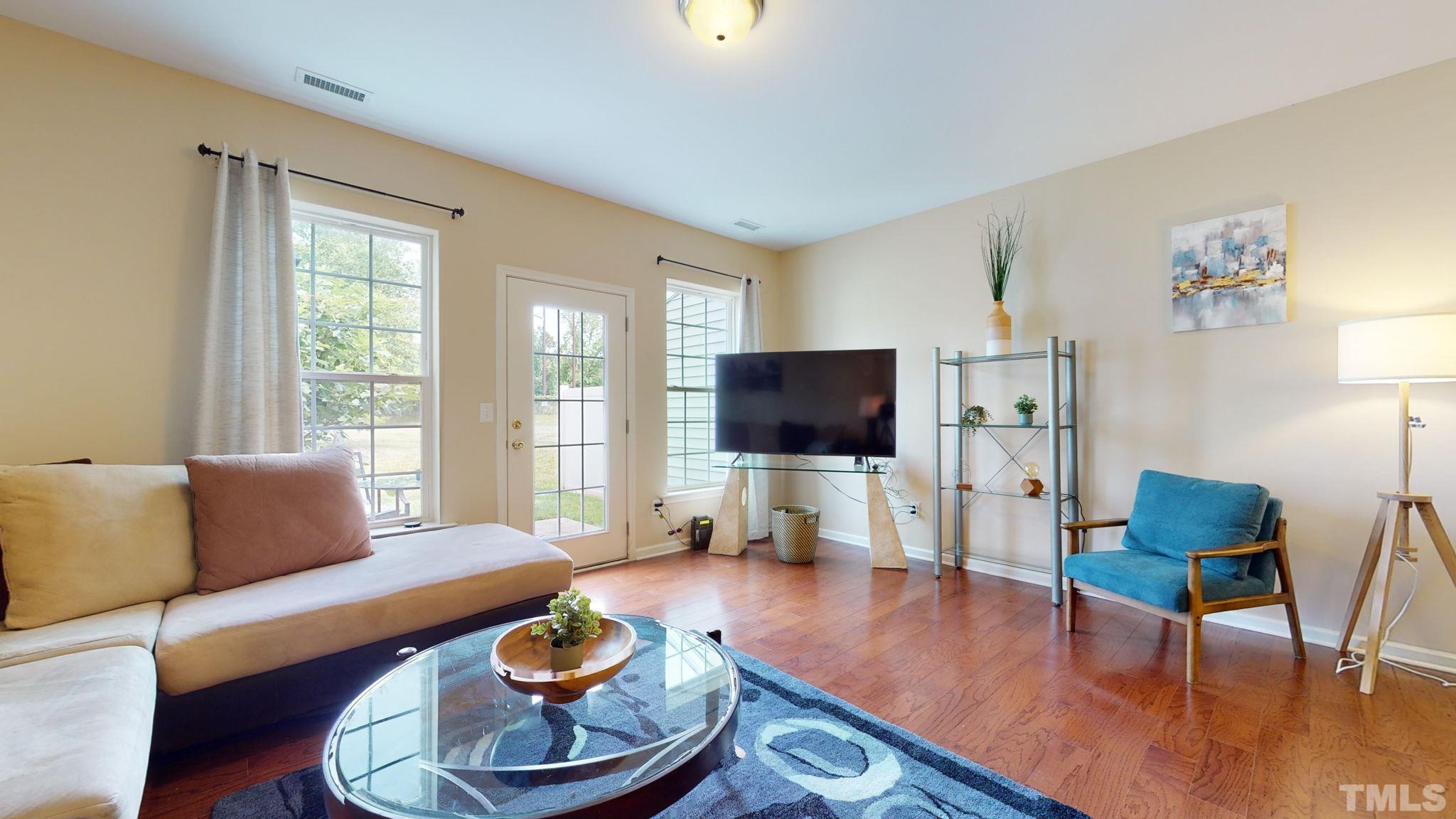 944 Consortium Drive Raleigh, NC 27603 - Photo 11 of 30 a living room with furniture and a flat screen tv
