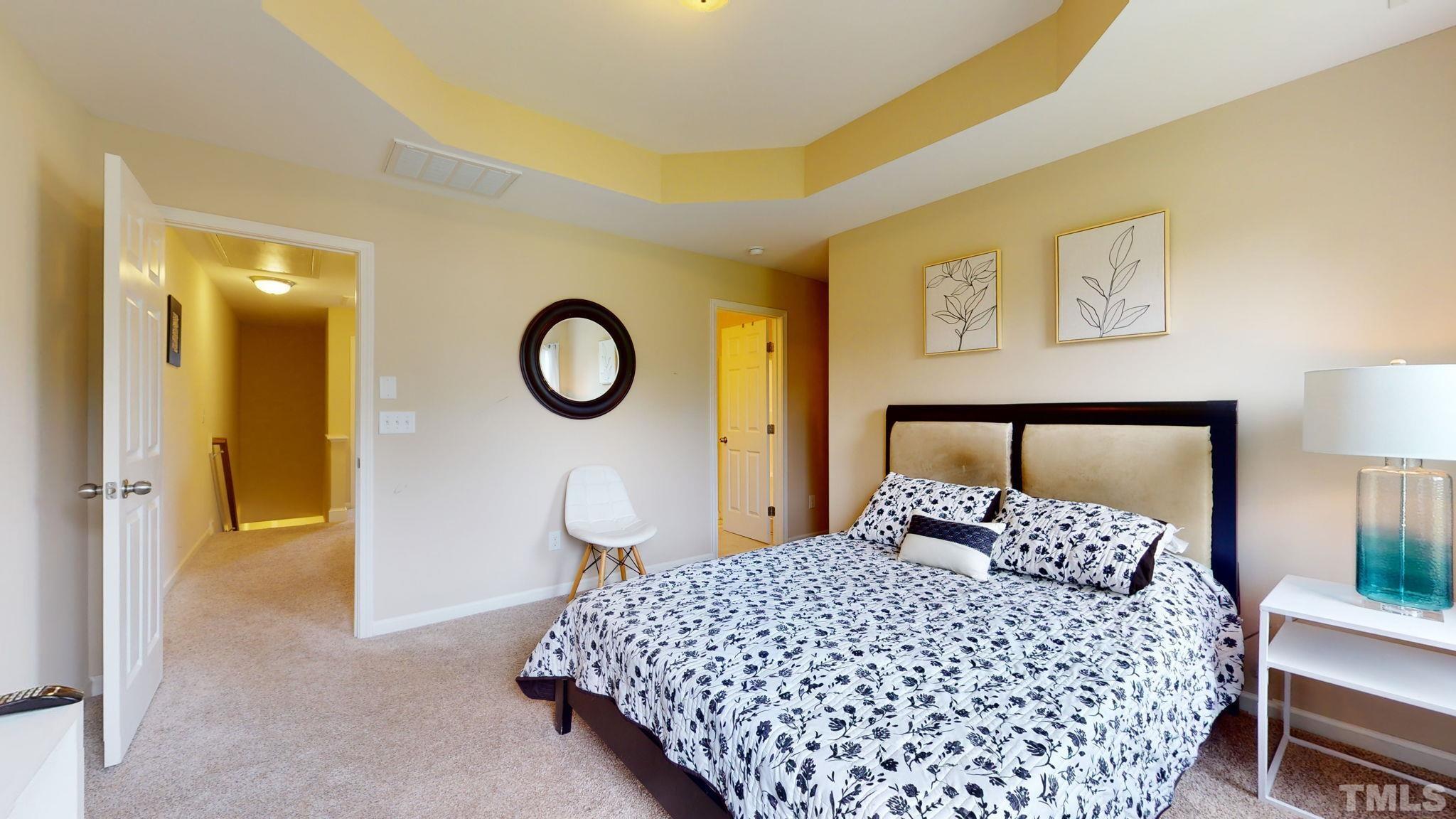 944 Consortium Drive Raleigh, NC 27603 - Photo 20 of 30 a bedroom with a bed and a painting on the wall