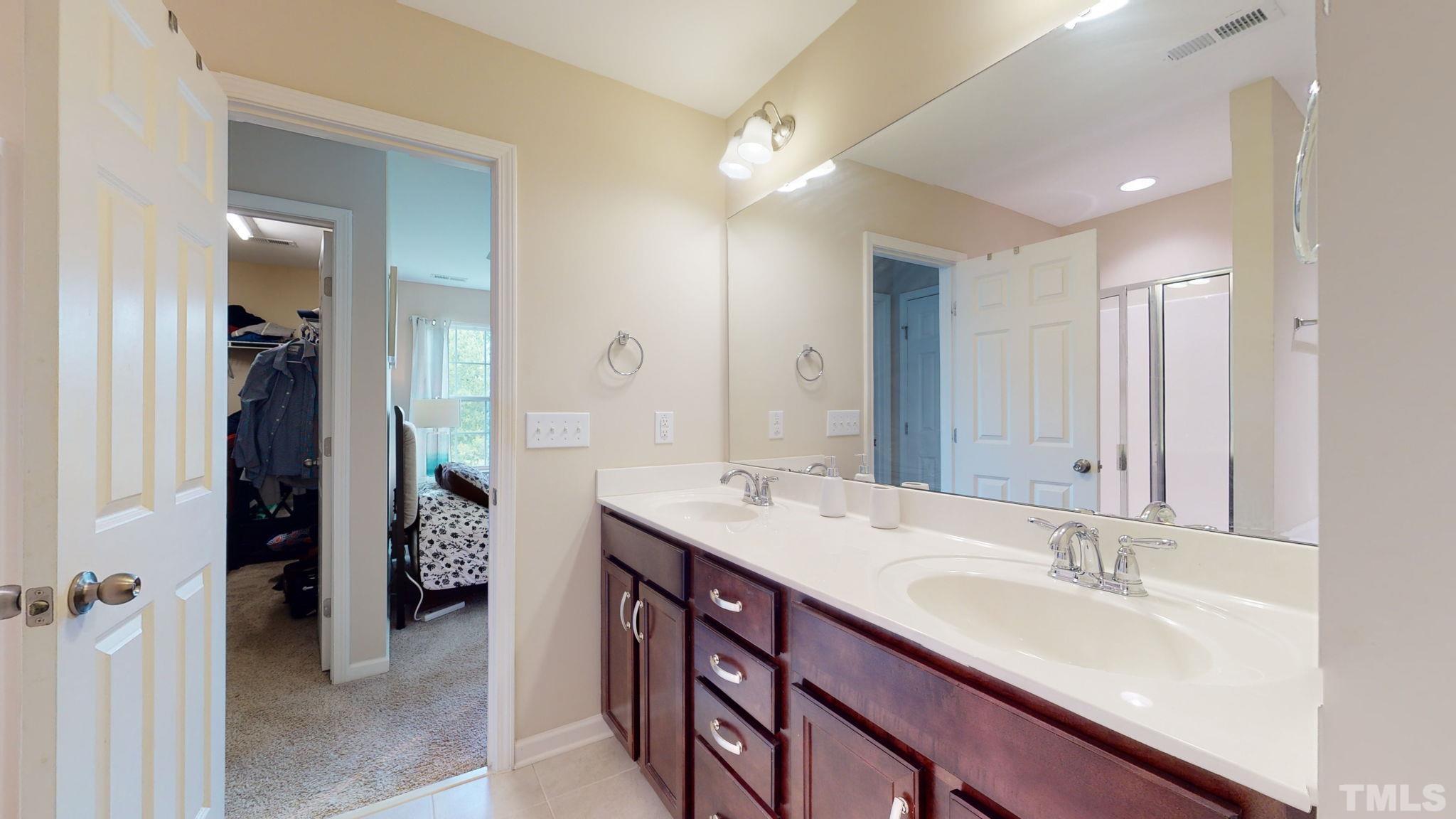 944 Consortium Drive Raleigh, NC 27603 - Photo 21 of 30 a bathroom with a sink double vanity and a mirror