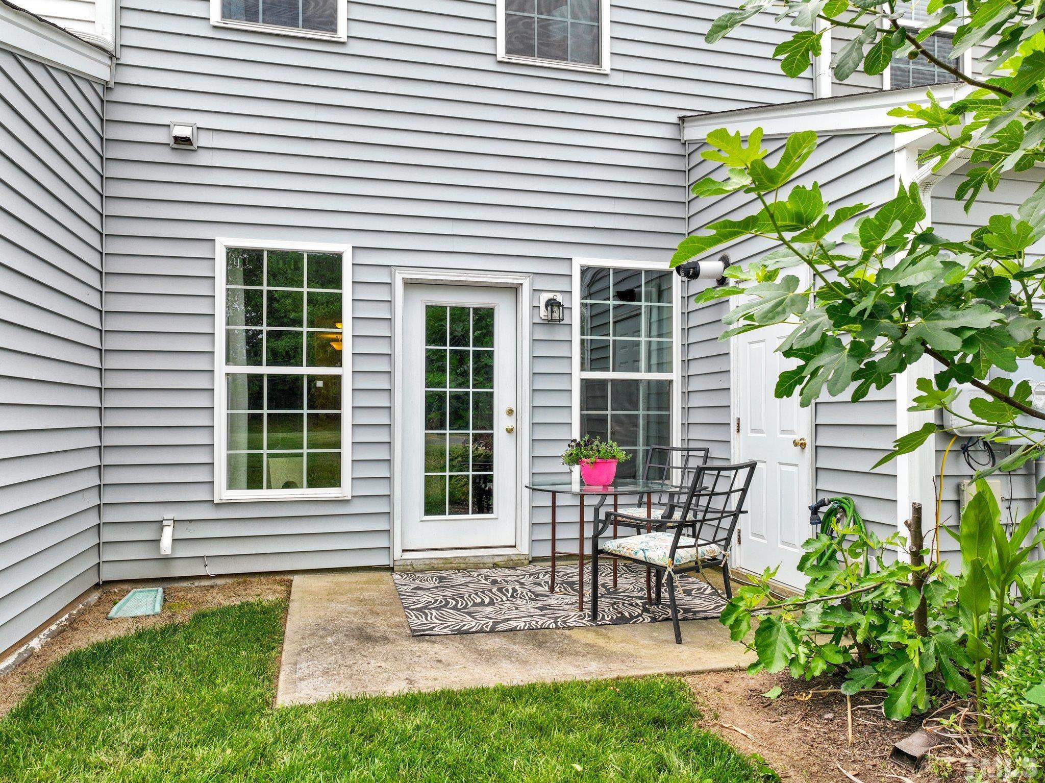 944 Consortium Drive Raleigh, NC 27603 - Photo 28 of 30 a view of a house with a chairs and table in a patio