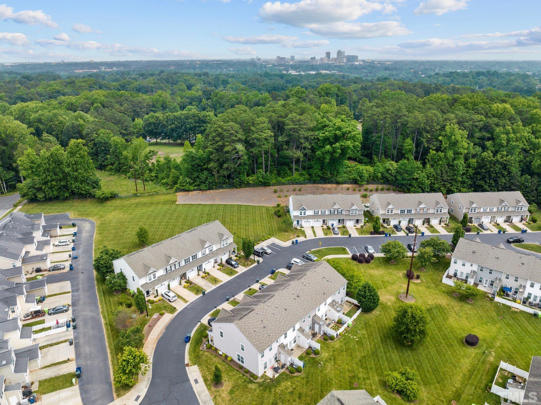 944 Consortium Drive Raleigh, NC 27603 - Photo 5 of 30 an aerial view of a house with pool large trees and yard