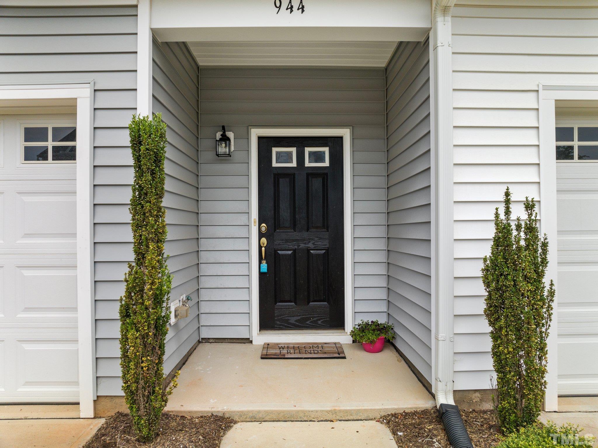 944 Consortium Drive Raleigh, NC 27603 - Photo 8 of 30 a potted plant sitting in front of a door