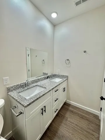 a view of a room with wooden floor