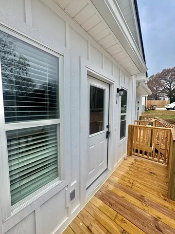 a kitchen with stainless steel appliances kitchen island wooden floors and view living room