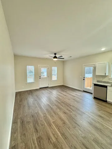 a kitchen with granite countertop cabinets sink and stainless steel appliances