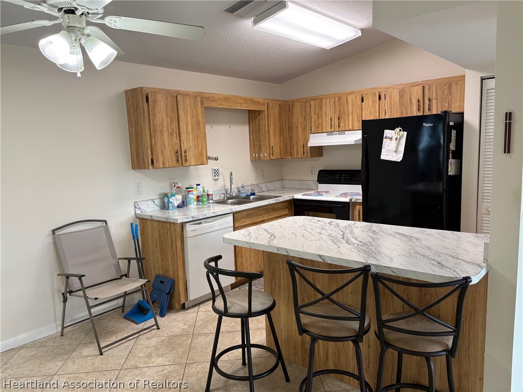3913 Ferrari Drive Sebring, FL 33872 - Photo 7 of 20 a kitchen with a table chairs and a refrigerator