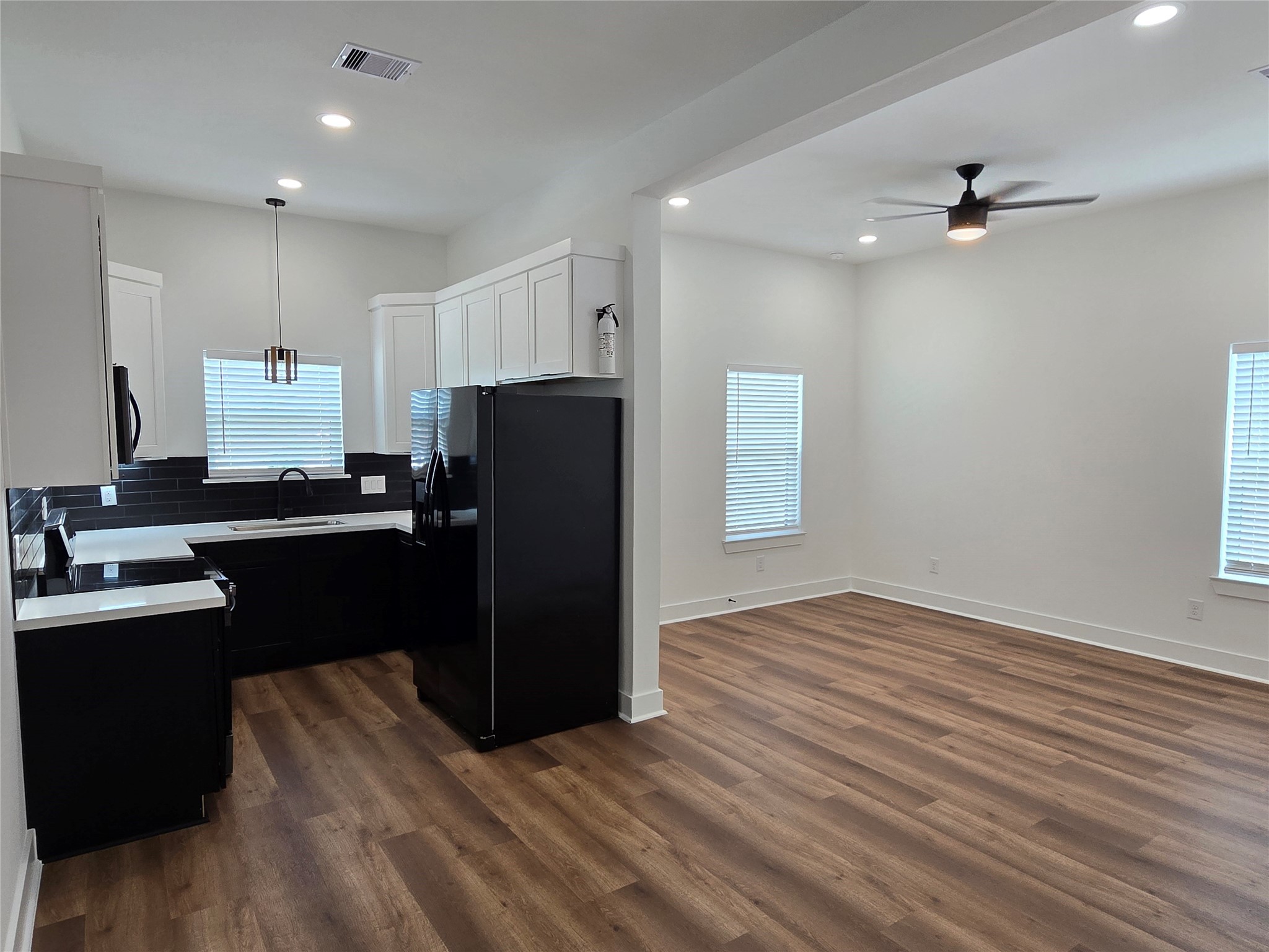 9808 Pelsey Street, Unit B Houston, TX 77029 - Photo 3 of 17 a kitchen with a refrigerator and a sink