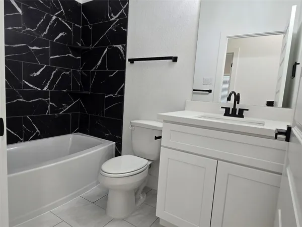 a bathroom with a sink a toilet and a bathtub