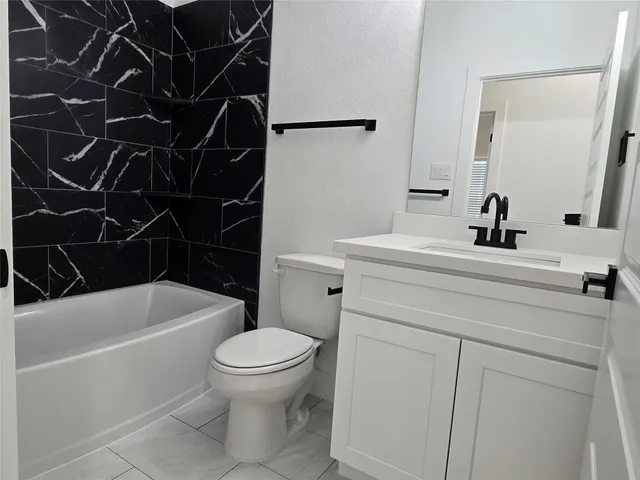 a bathroom with a sink a toilet and a bathtub