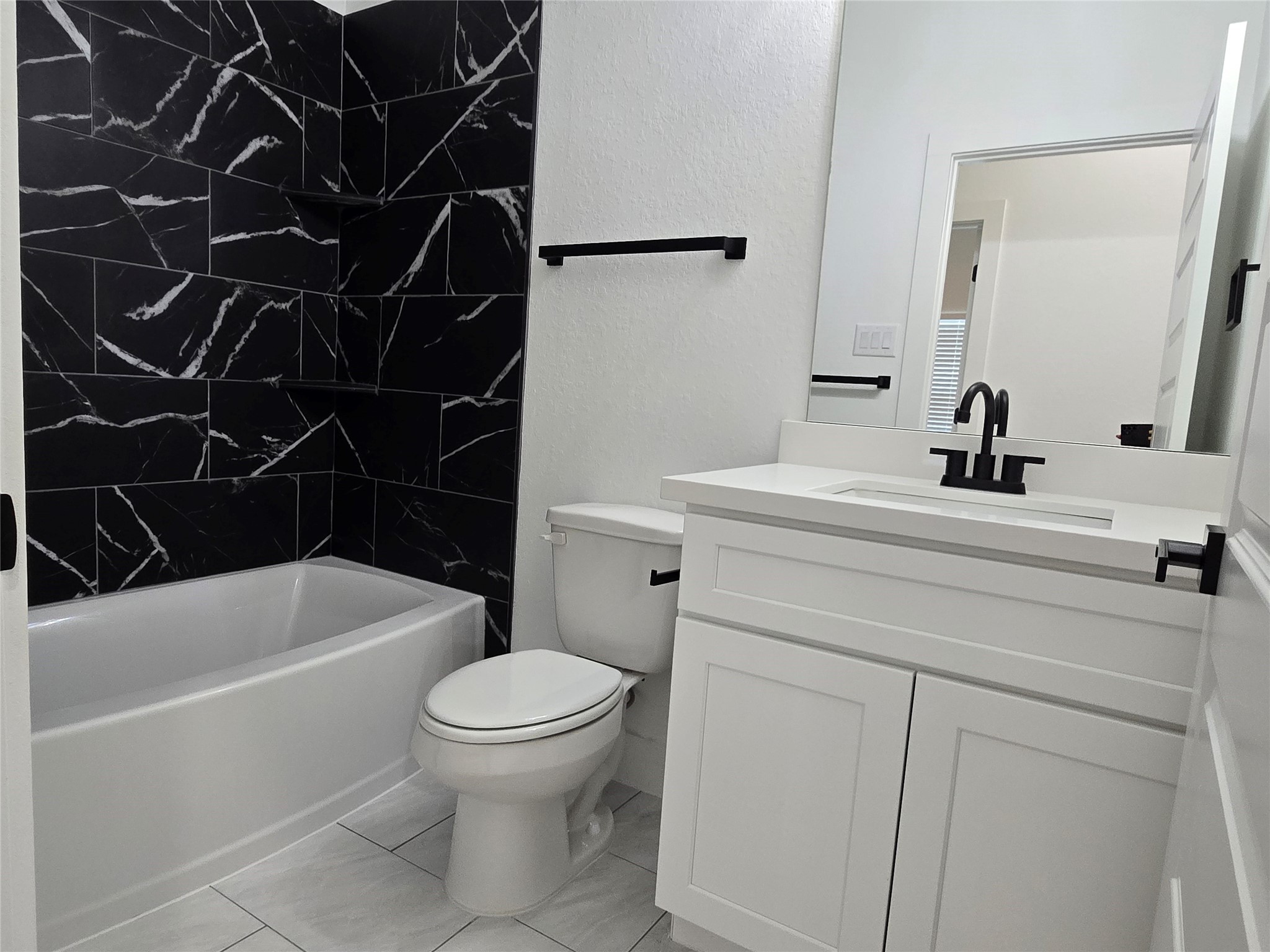 9808 Pelsey Street, Unit B Houston, TX 77029 - Photo 7 of 17 a bathroom with a sink a toilet and a bathtub