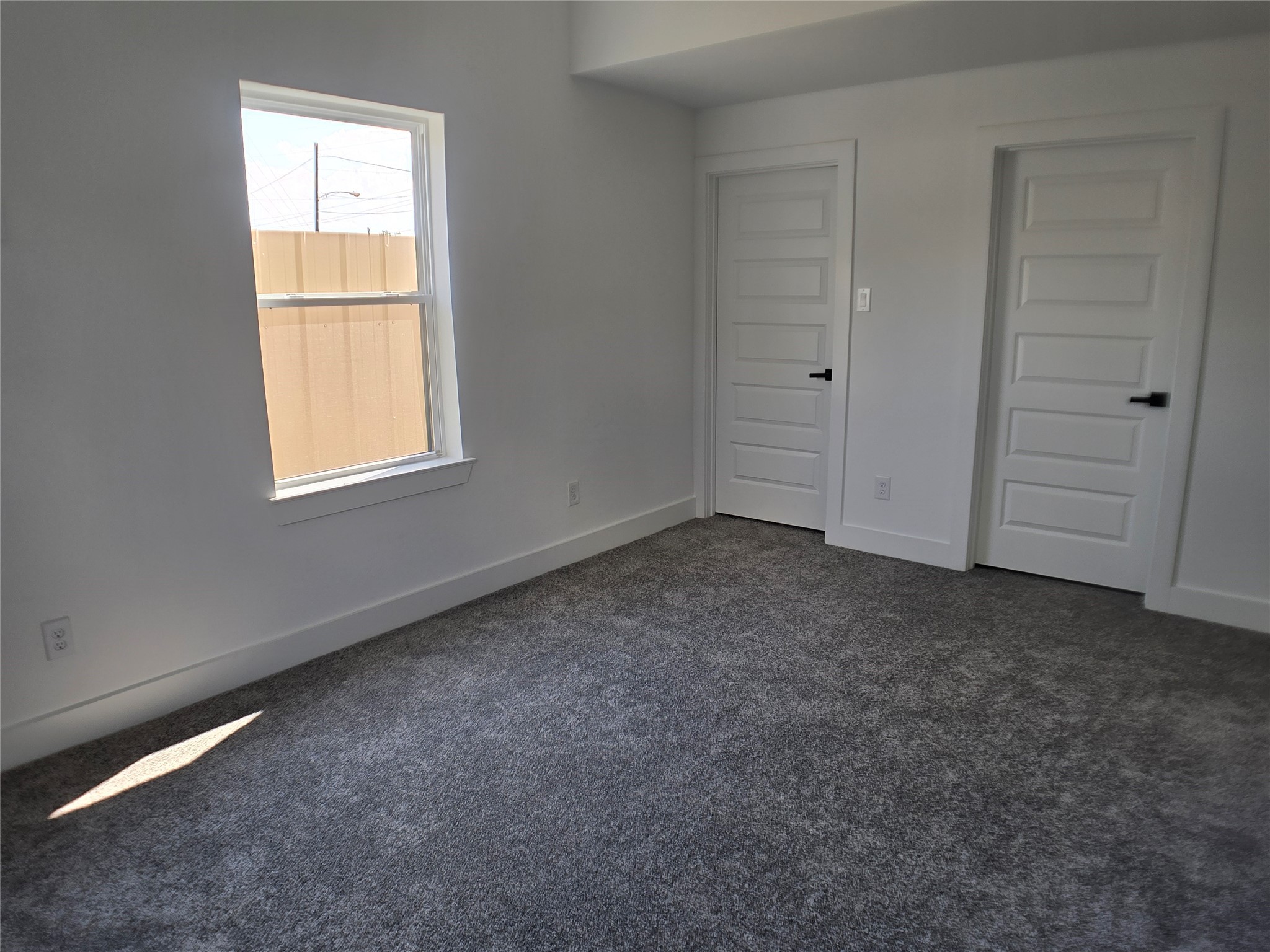 9808 Pelsey Street, Unit B Houston, TX 77029 - Photo 9 of 17 an empty room with windows