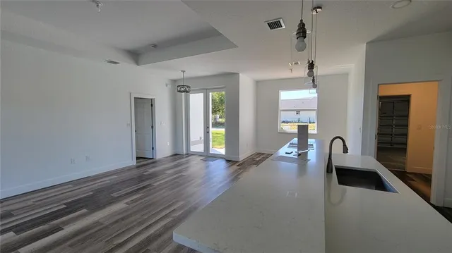 a kitchen with stainless steel appliances granite countertop a stove a microwave and a refrigerator