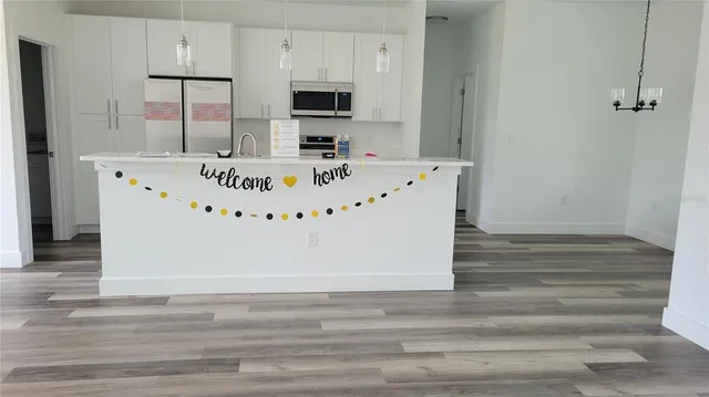 a living room with furniture a flat screen tv and a large window