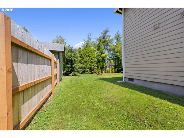 a view of backyard with a garden and deck
